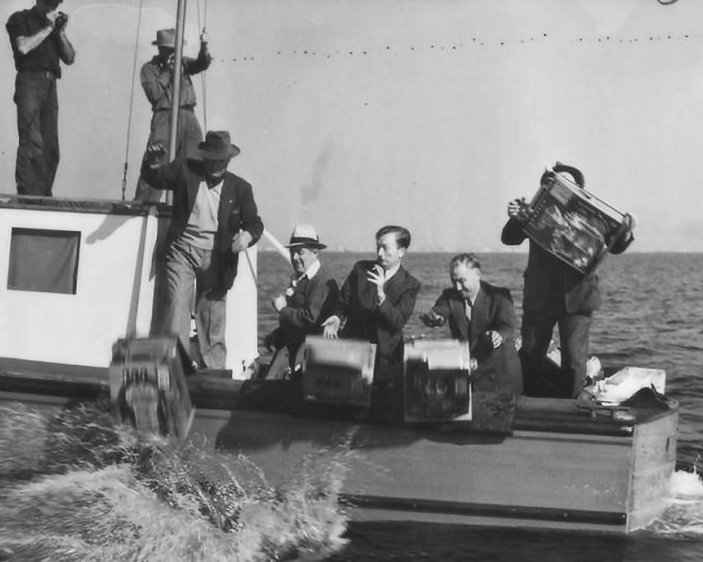 Confiscated slots from SS Tango being thrown overboard into the sea.